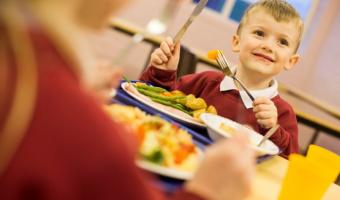 Photo of schoolboy eating at Hounslow School, Compass