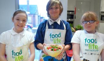 Picture of schoolchildren in Stoke learning aboard the Cooking Bus