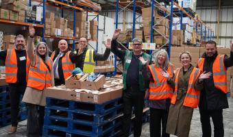 Staff from City Catering, Bidfood, Comax and Harvest Fine Foods prepare boxes