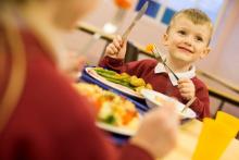 Photo of schoolboy eating at Hounslow School, Compass