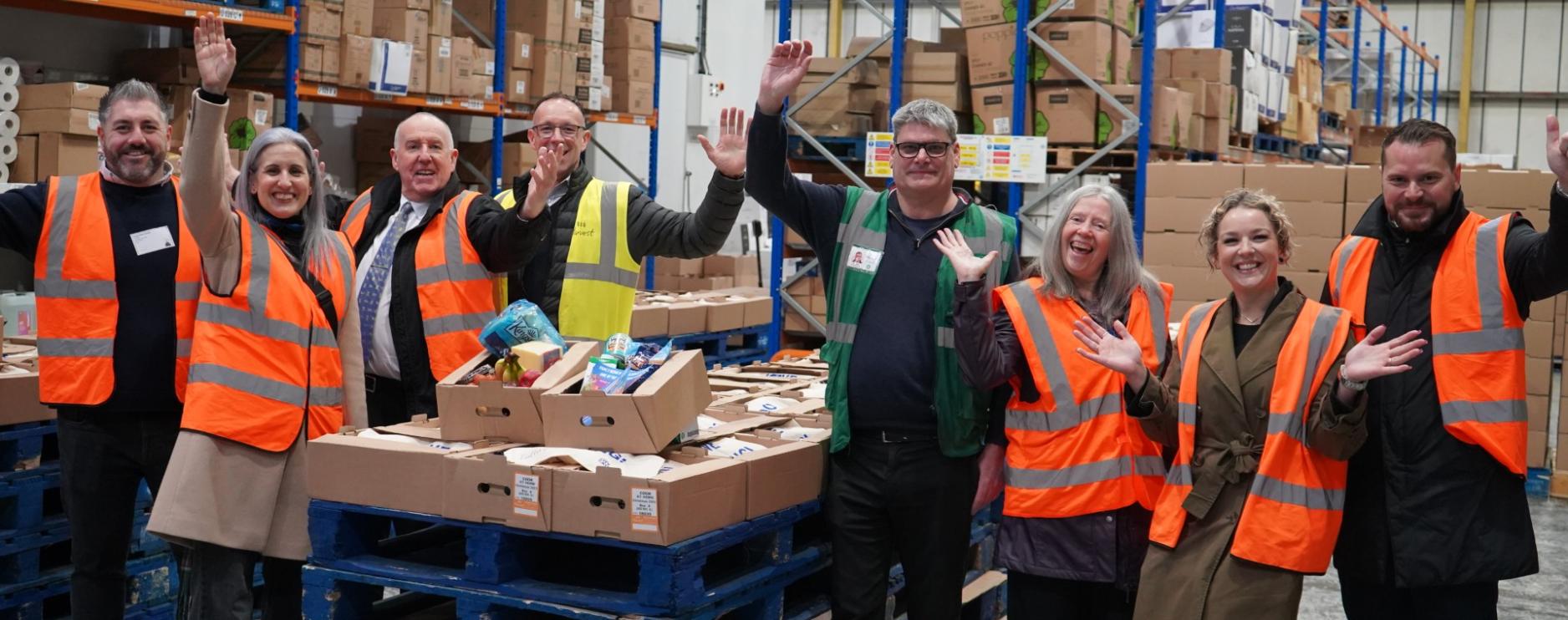 Staff from City Catering, Bidfood, Comax and Harvest Fine Foods prepare boxes