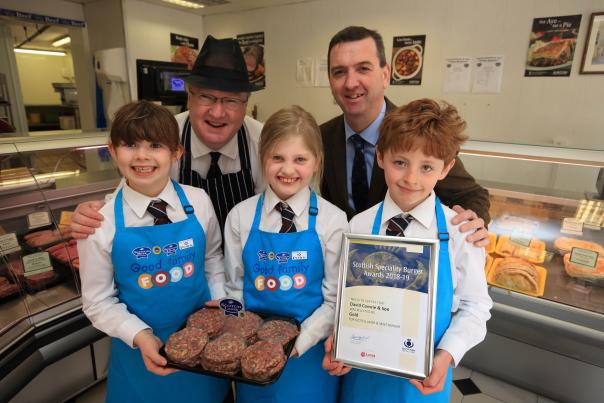 (L-R) Murray Lauchlan (David Comrie Butchers) with Bruce McCall of Scottish Craft Butchers, and Morrisons Academy primary 4 students
