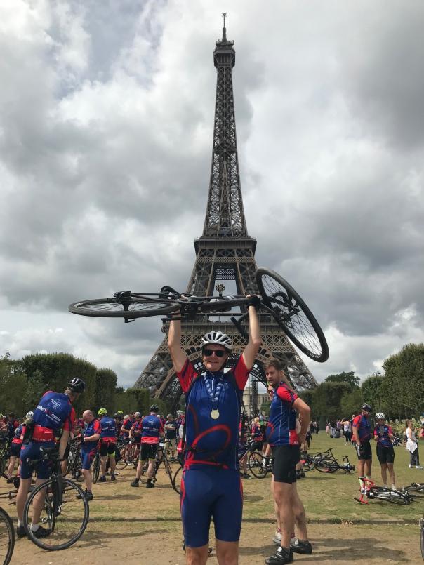 Jon Leigh celebrating after reaching Paris Compass Group raises £33,750 for Alzheimer’s Society