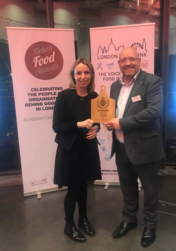 Hayley Johnson and Dennis Brewin collecting award