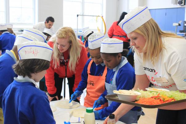 City Year UK corps member Maria Arthur-Hartnett with Aramark's Claire Corley at Sebright School, Hackney Image of City Year UK and Aramark team at Sebright School, Hackney