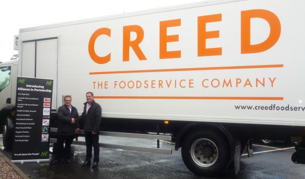 AiP Managing Director David Weller (left) and Creed Foodservice shake hands on their partnership.