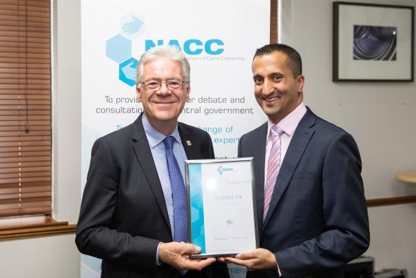 Roger Kellow receiving his award from Neel Radia
